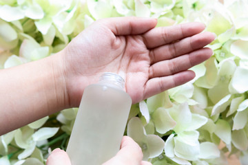 Facial cleansing toner drops on the palm.