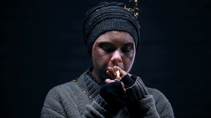 Female bum lighting cigarette, living on street, homeless lifestyle, problem