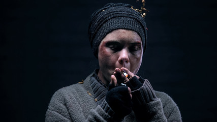 Dirty homeless person smoking cigarette, nicotine addiction, risk of cancer