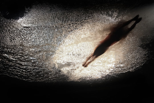 Person ready to dive in water