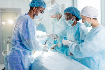skilled and registered doctors doing medical procedure. side view photo
