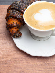 Italian cappuccino with fresh cornetti. Copy space