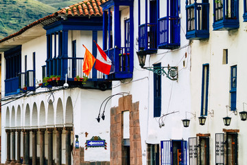 Blue balconies with flags in a colonial building of Cusco, Peru