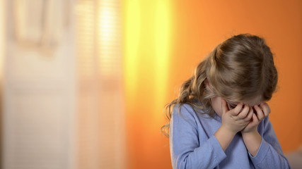 Little sad preschool girl crying having no friends, little orphan wanting family