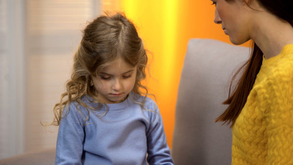 Mother talking with daughter about divorce problem, trying to support upset girl
