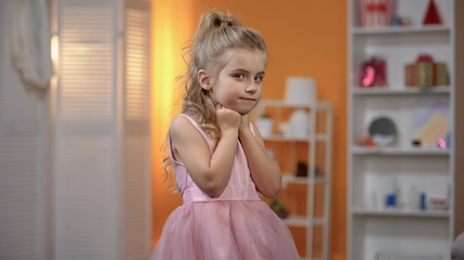 Beautiful girl in princess dress posing for camera, event center, celebration