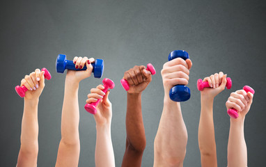 Man And Woman's Hand Holding Dumbbells In Green Backdrop