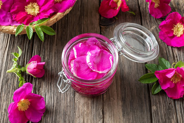 A bottle of essential oil with Rugosa roses