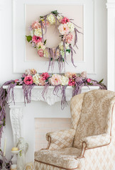 Floral decoration in the photo studio. Interior photo studio. Wedding decorations. Gentle spring flowers. flower composition. Armchair, candle and statuette of an angel