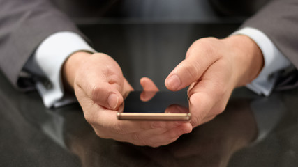 Company director holding expensive smartphone closeup, sending email, business