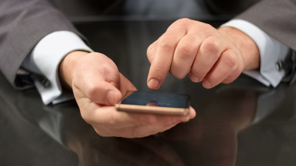 Businessman messaging on smartphone closeup, browsing internet site, email