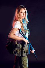 Beautiful caucasian female private military contractor with long blonde hair, dressed in tactical...