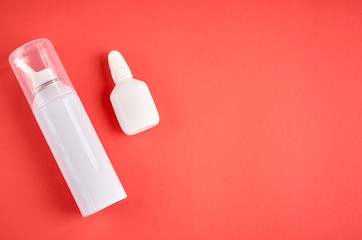 Nasal spray bottle composition, white template bottle on pink background