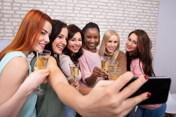 Women With Champagne Taking Selfie At Night Club