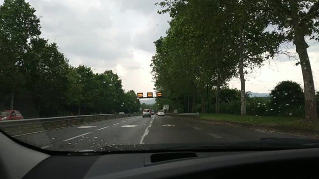 Turin, Piedmont, Italy. May 2019. Point of view from a car. Street light signage alerts motorists on the speed limit and the presence of cameras for the detection of electronic infringements. 25fps