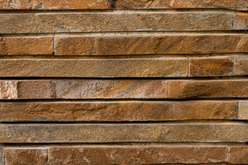 geometric lined brown textured background and copy space with brick stones 