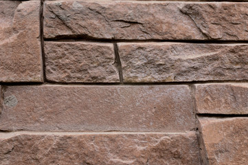 close up of geometric brick stone brown texture background, wall surface facade