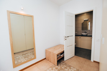 modern light interior. room with white walls and wooden floor.
