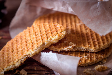 Still life with round waffers on wooden rustic background