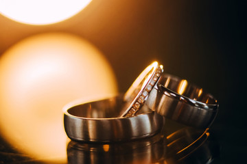 wedding rings. jewelery in white and yellow gold. Wedding ring on the mirror surface.