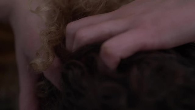 Closeup of young curly woman getting a head massage