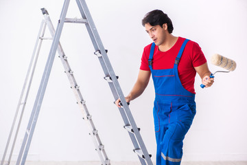 Young handsome contractor working indoors 