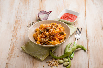 fettuccine pasta with broad bean tomato and pine nuts