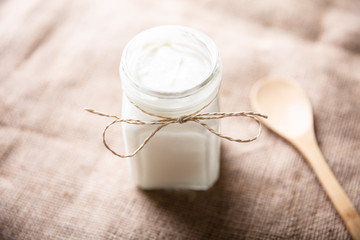 Yogurt In Jar Near Wooden Spoon