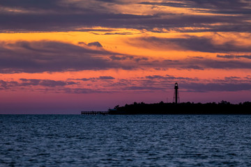 Point Ybel Light at Daybreak - Gorgeous colors fill the sky at daybreak silhouetting the Point Ybel Light, a metal lighthouse on Sanibel Island, Florida.