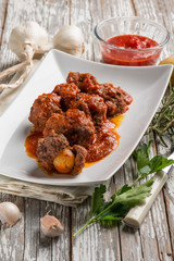 meatball with tomatoes sauce filled with potatoes