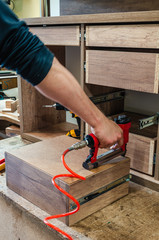 red pneumatic stapler in a furniture workshop