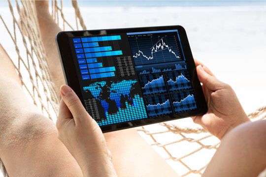 Close-up Of A Woman Analyzing The Graph On Digital Tablet - Powered by Adobe