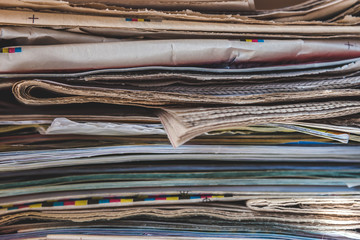 Pile of old newspapers and magazines, stack, side view.  Vintage background