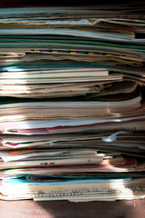Pile of old newspapers and magazines, stack, side view.  Vintage background