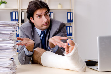 Leg injured employee working in the office 