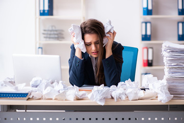 Businesswoman rejecting new ideas with lots of papers