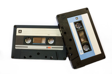 Two black compact cassette with blank coloured labels