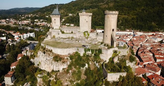 Aerial view of impressive medieval castle on rocky outcrop in French commune of Foix