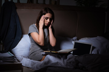 Fototapeta premium Tired businesswoman working overtime at home at night