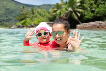 Mother And Daughter Swimming In The Sea