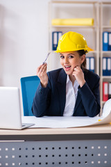 Young female architect working in the office 