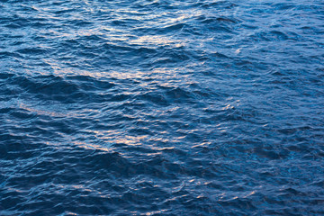 Blue little waves at sunset