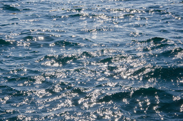 Abstract sea background, colorful ripples of water surface