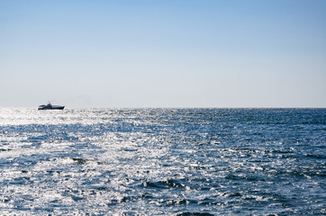 Colorful seascape, view of ship on horizon, sea and blue sky