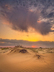 beautiful morning with clouds and sand in golden hours in desert in the morning