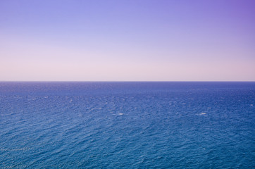 Seascape, view of sea horizon and colorful sky at sunset