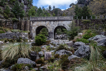 Fototapeta na wymiar Small mountain bridge over a creek from the Peneda Geres National Park, north of Portugal.