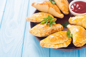Latin American baked beef empanadas with sauce