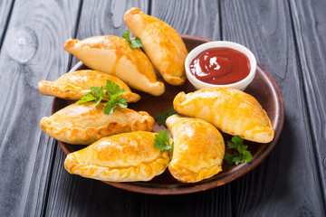 Latin American baked beef empanadas with sauce