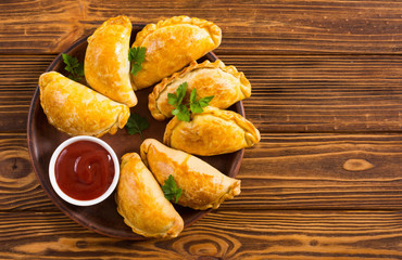 Latin American baked beef empanadas with sauce